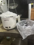 Dezin Electric Hot Pot With Stainless Steel Steamer Beige. Fixed Price $30.00.